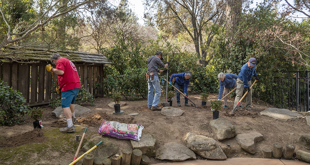 Shinzen Friendship Garden volunteers digging holes to plant new foliage